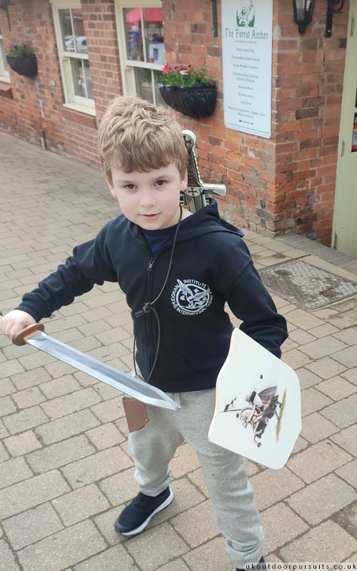 Leaving the armoury with a shield and sword
